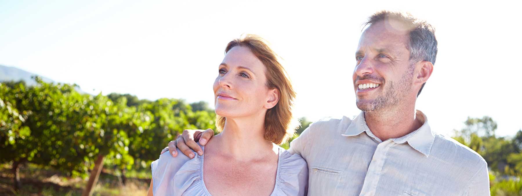 Couple standing in vineyard