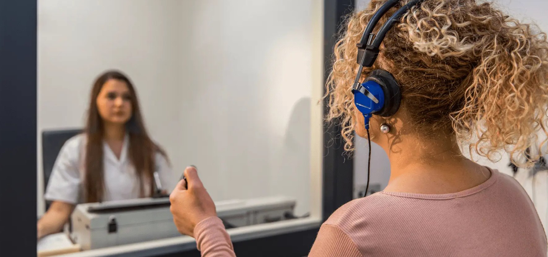 Audiologist performing hearing test